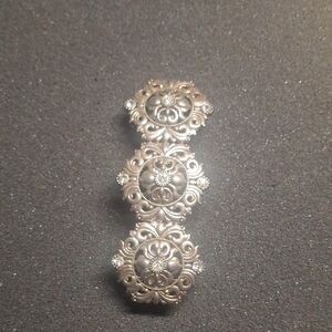 Ornate Silver-Tone Floral Brooch with Crystal Accents
